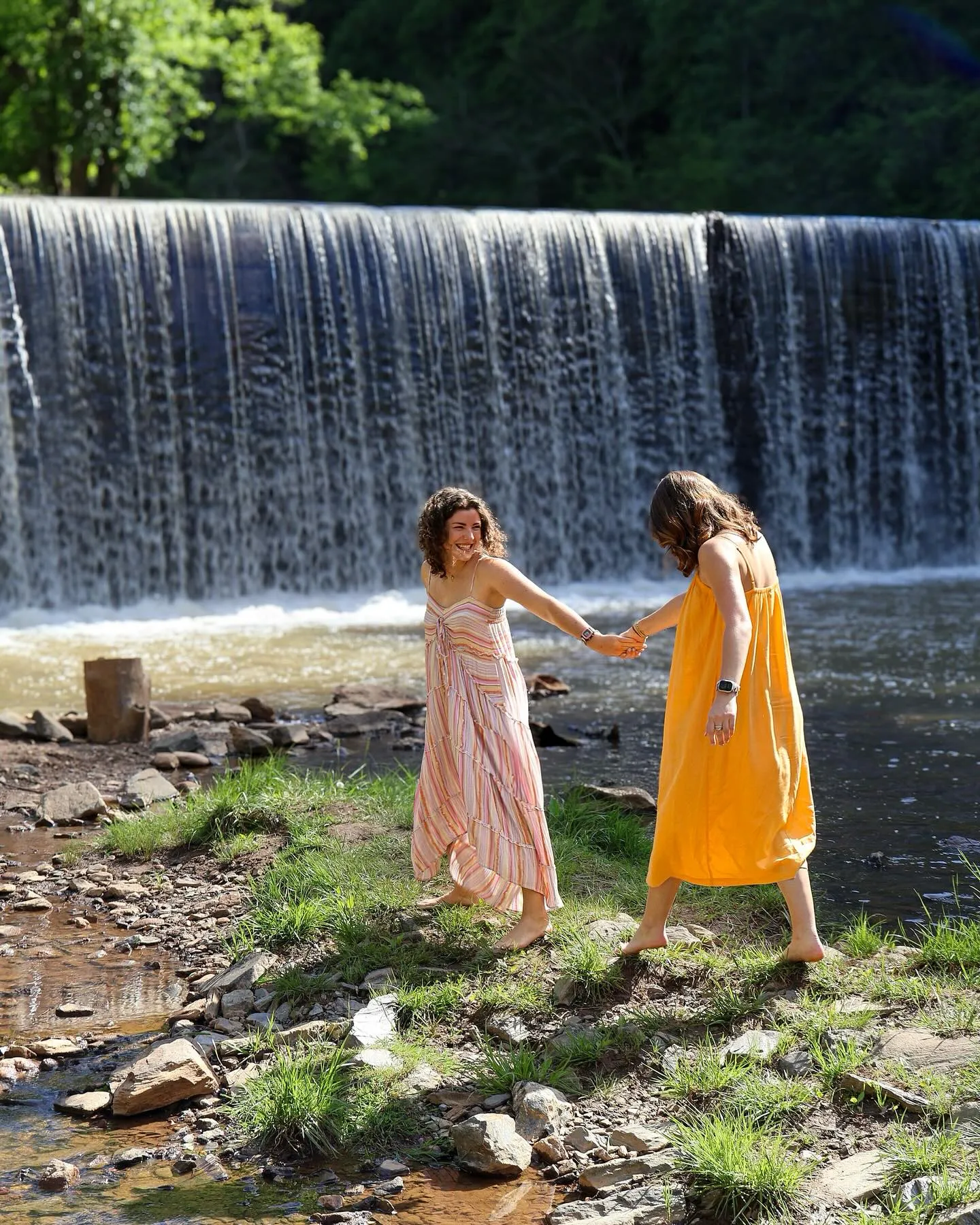 Picture of two girls infront of waterfall