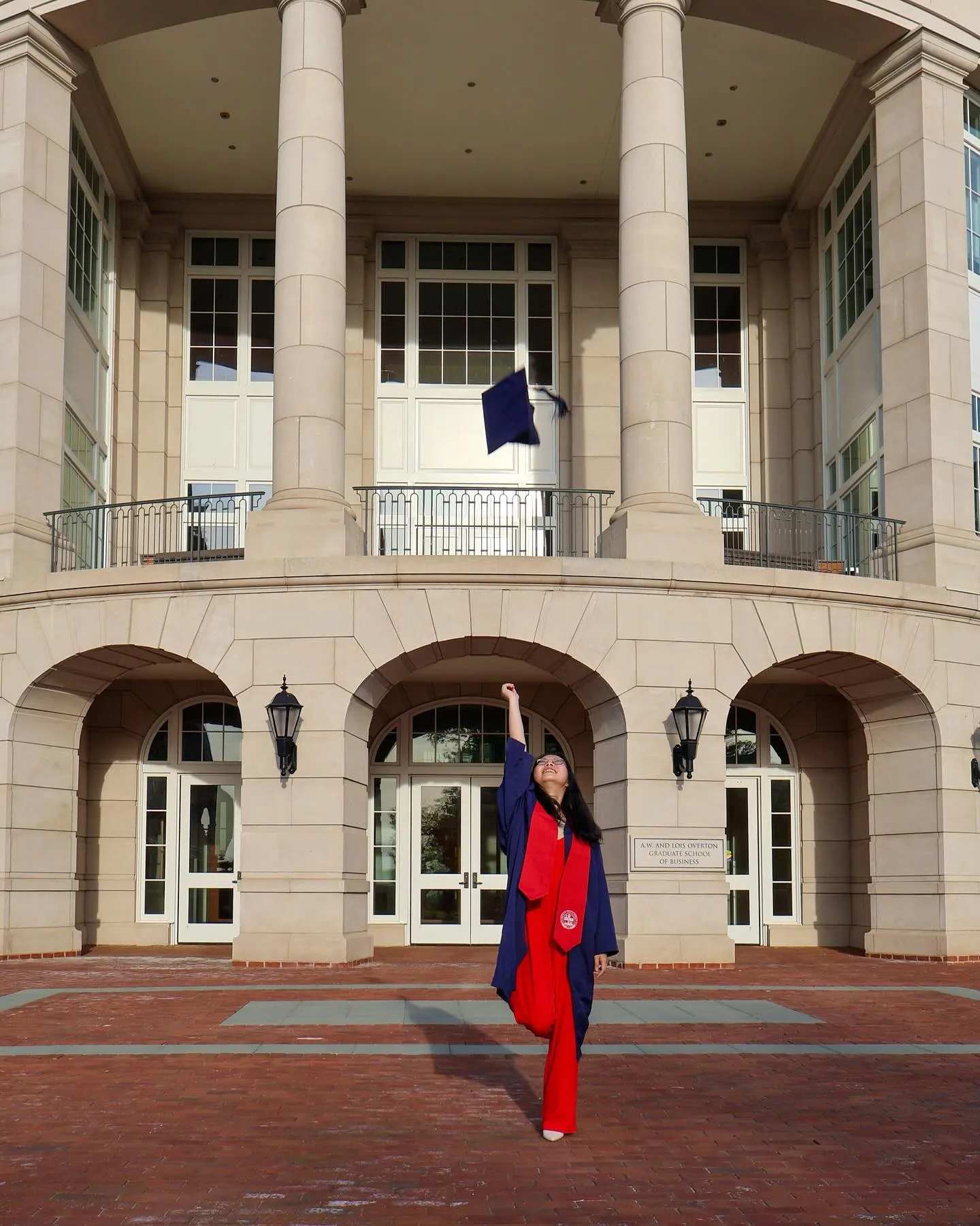 Picture of student graduating infont of building