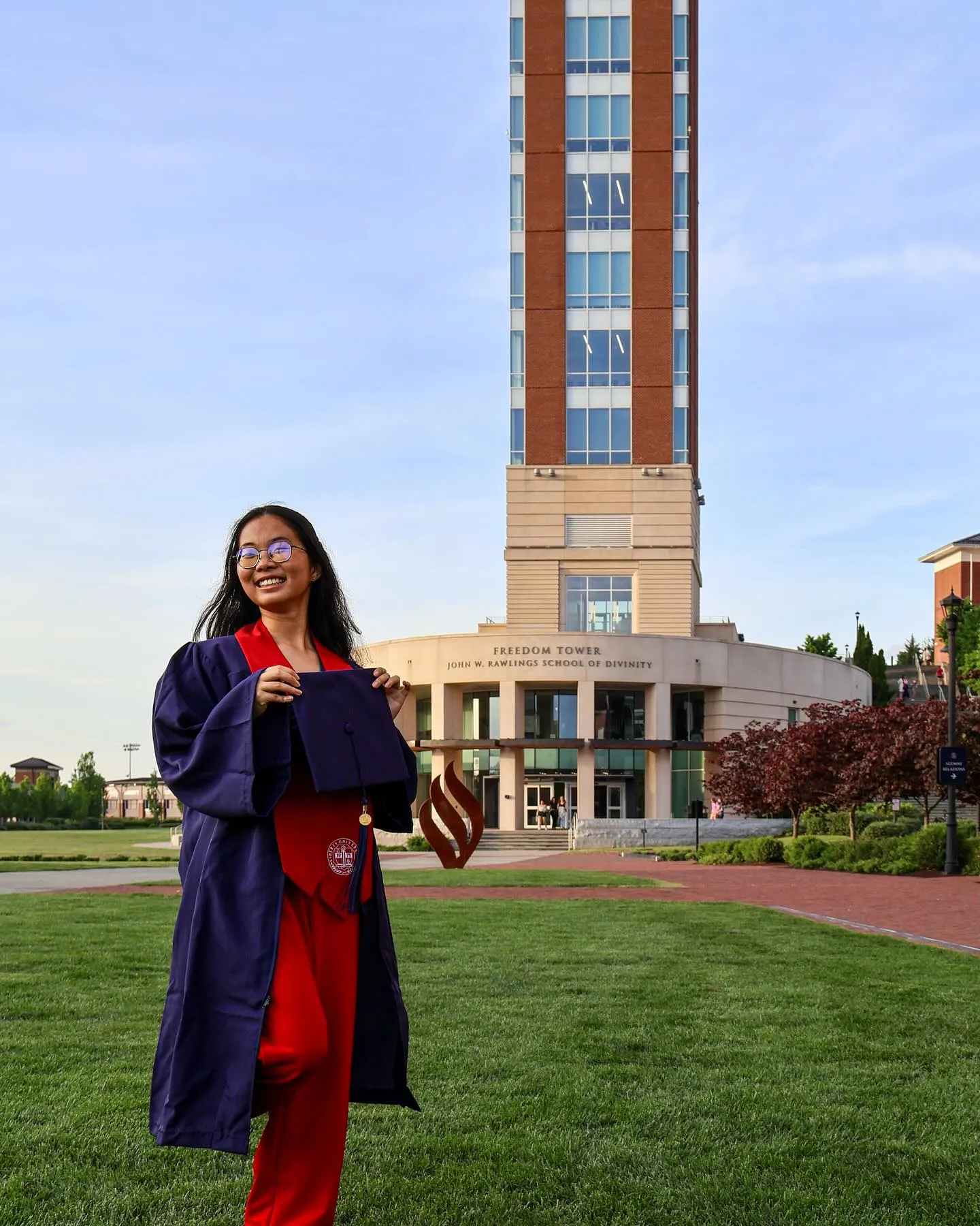 Picture of student graduating nearby tower
